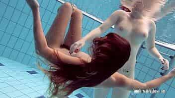 Katrin swims and strips Lucy in the swimming pool video